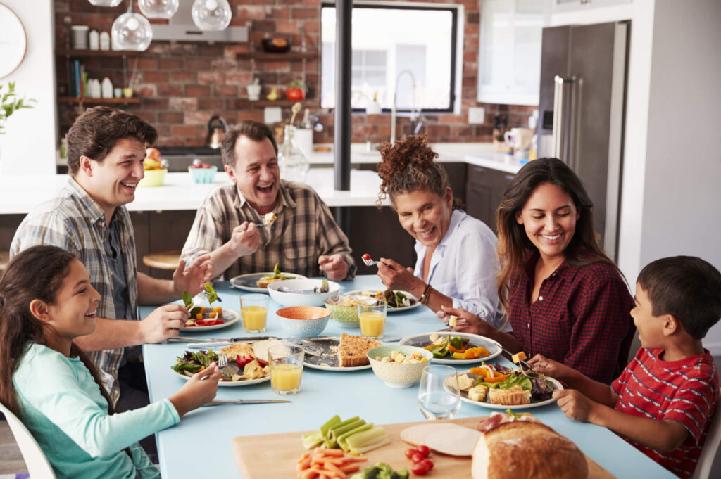 Large family enjoying a meal around table together