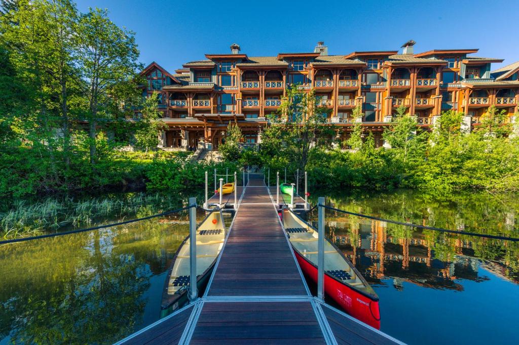 Exterior photo of Nita Lake Lodge in Canada, taken in summer from the dock on the lake