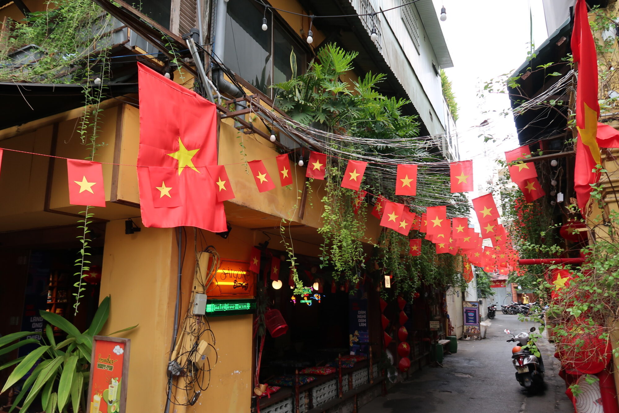Vietnamese flags flying in an alley way in Saigon