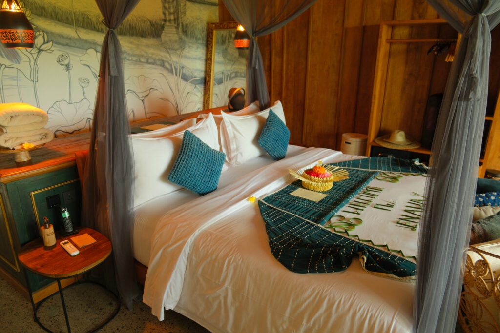 King bed with mosquito netting and pool view inside Teja villa Akohara Buahan Bali