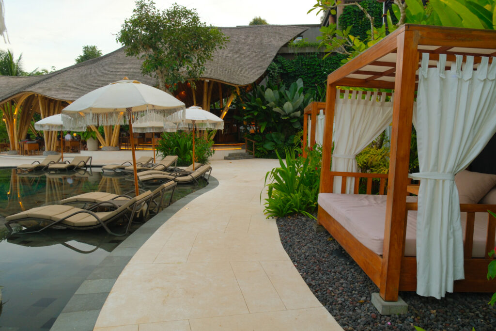 Heated main infinity pool with cabanas and sunlounges at Akohara Buahan Village Retreat Bali