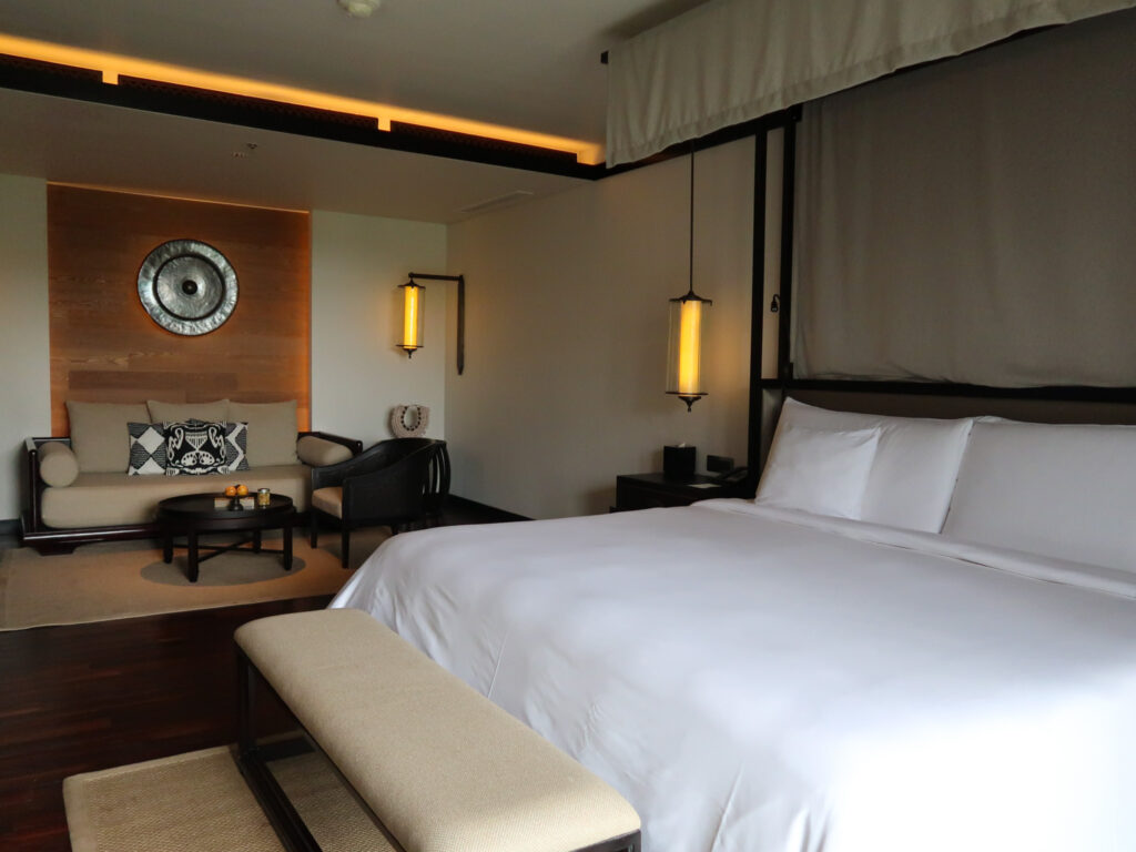 Guest hotel room and bed at The Apurva Kempinski