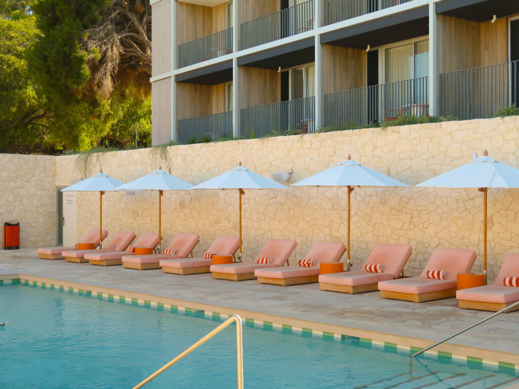Sunbeds lining the pool at The Lodge Wadjemup