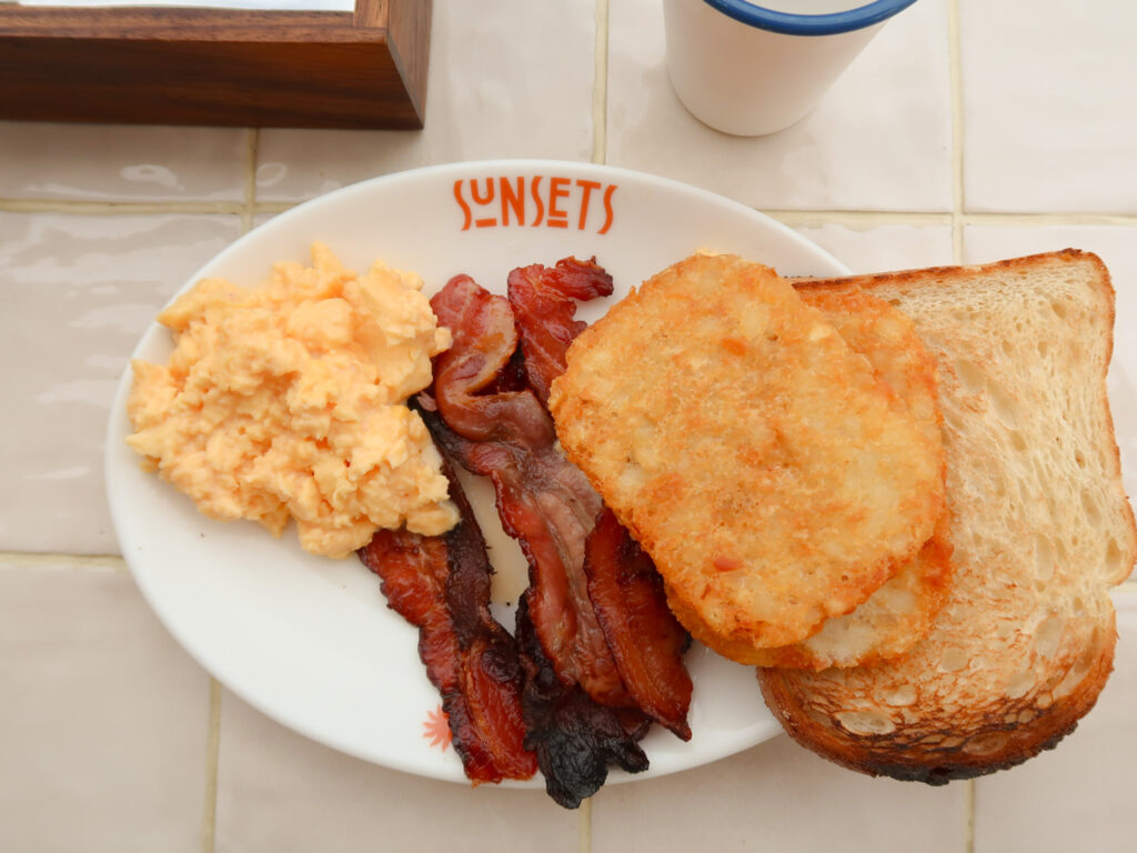 Scrambled eggs, bacon, hash browns and toast breakfast at Sunsets Bar and Dining at The Lodge Wadjemup