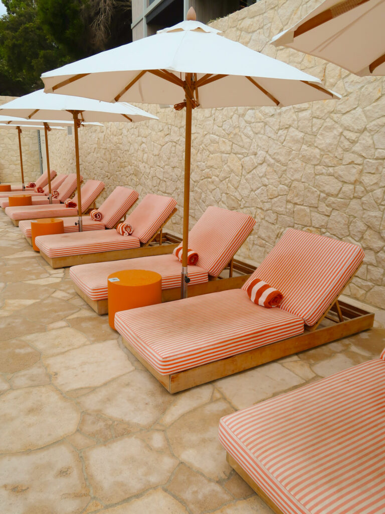 Orange sunlounges at The Lodge Wadjemup